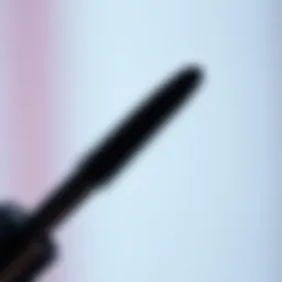 Close-up of a mini mascara wand applicator showcasing its unique bristle design