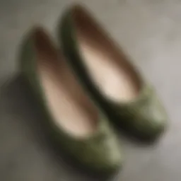 Close-up of olive green flat shoes showcasing intricate details and texture