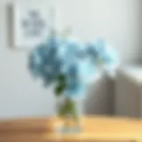 Elegant arrangement of ice blue artificial flowers in a minimalist vase.