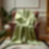 Elegant sage green satin robe draped gracefully on a plush chair