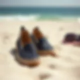 A pair of stylish slip-on shoes on a sandy beach