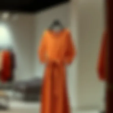 Elegant orange modest dress on a hanger